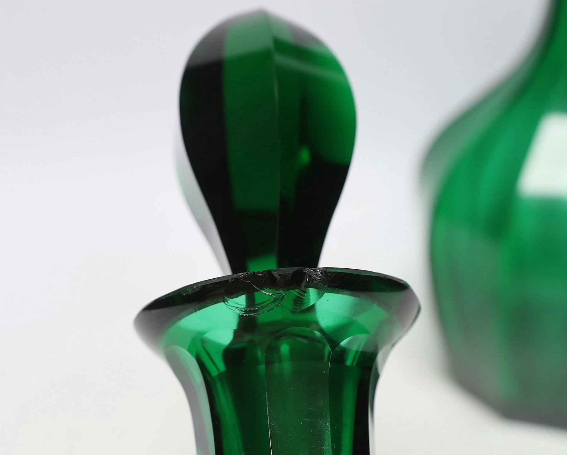 A pair of 19th century green glass decanters with stoppers, 34cm high